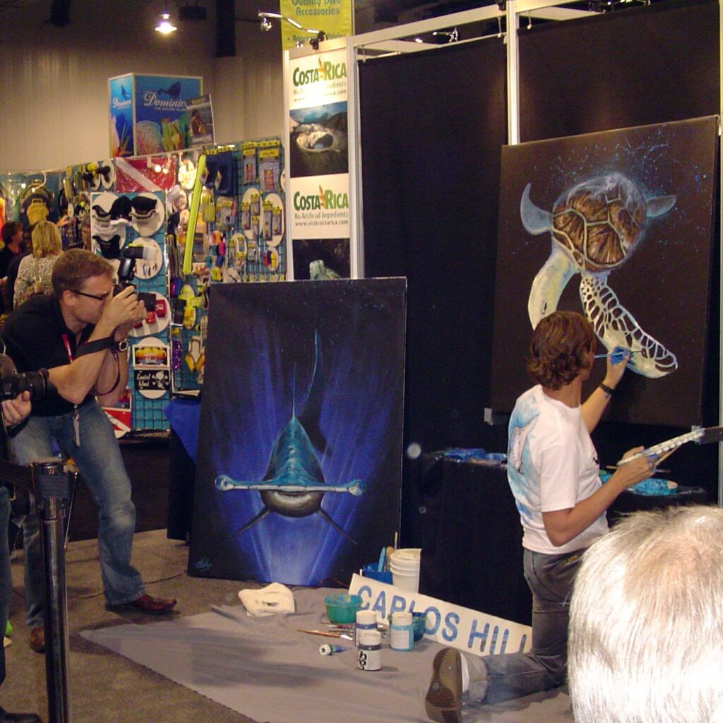 Carlos Hiller painting live at DEMA show in Las Vegas.