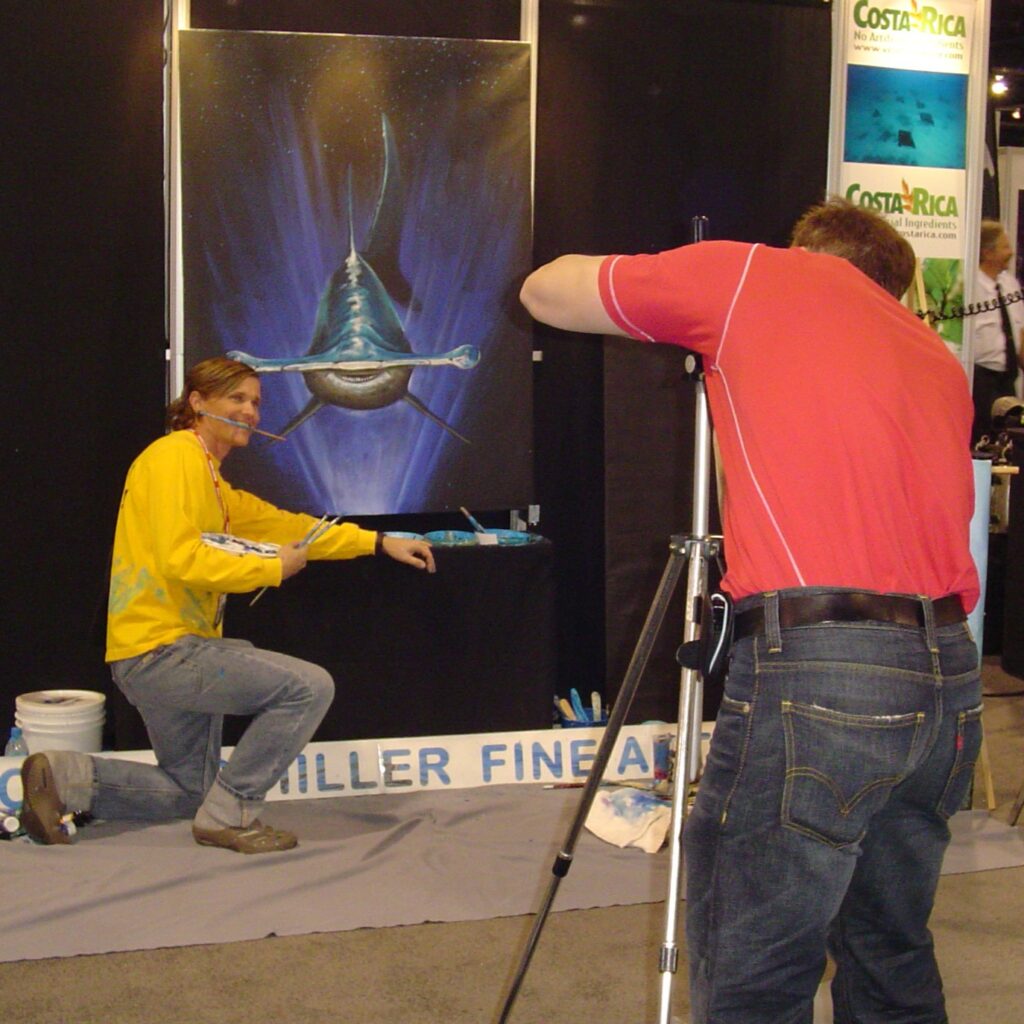 Carlos Hiller underwater artist painting live at DEMA show Las Vegas.